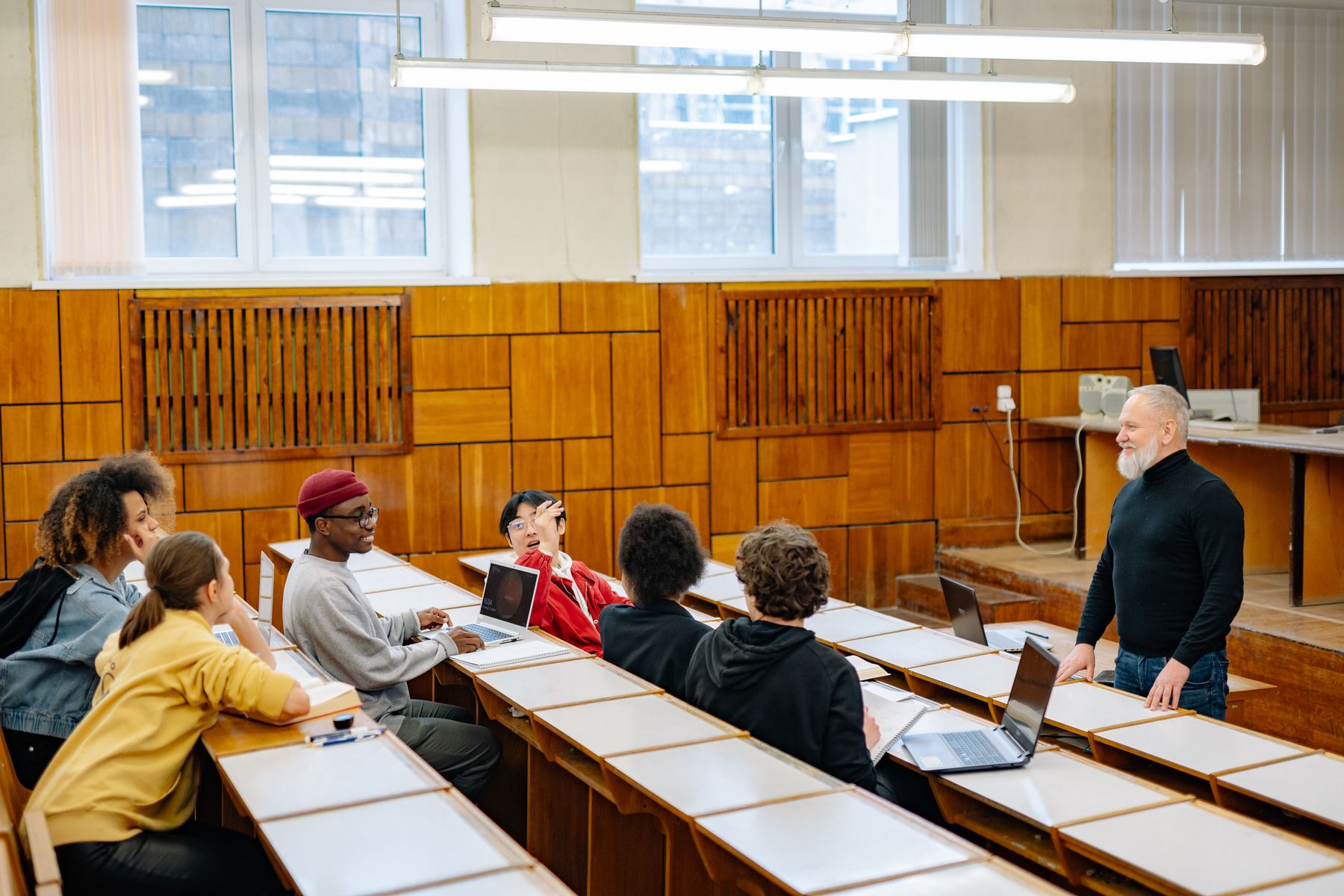 Students and an educator participating in a classroom discussion