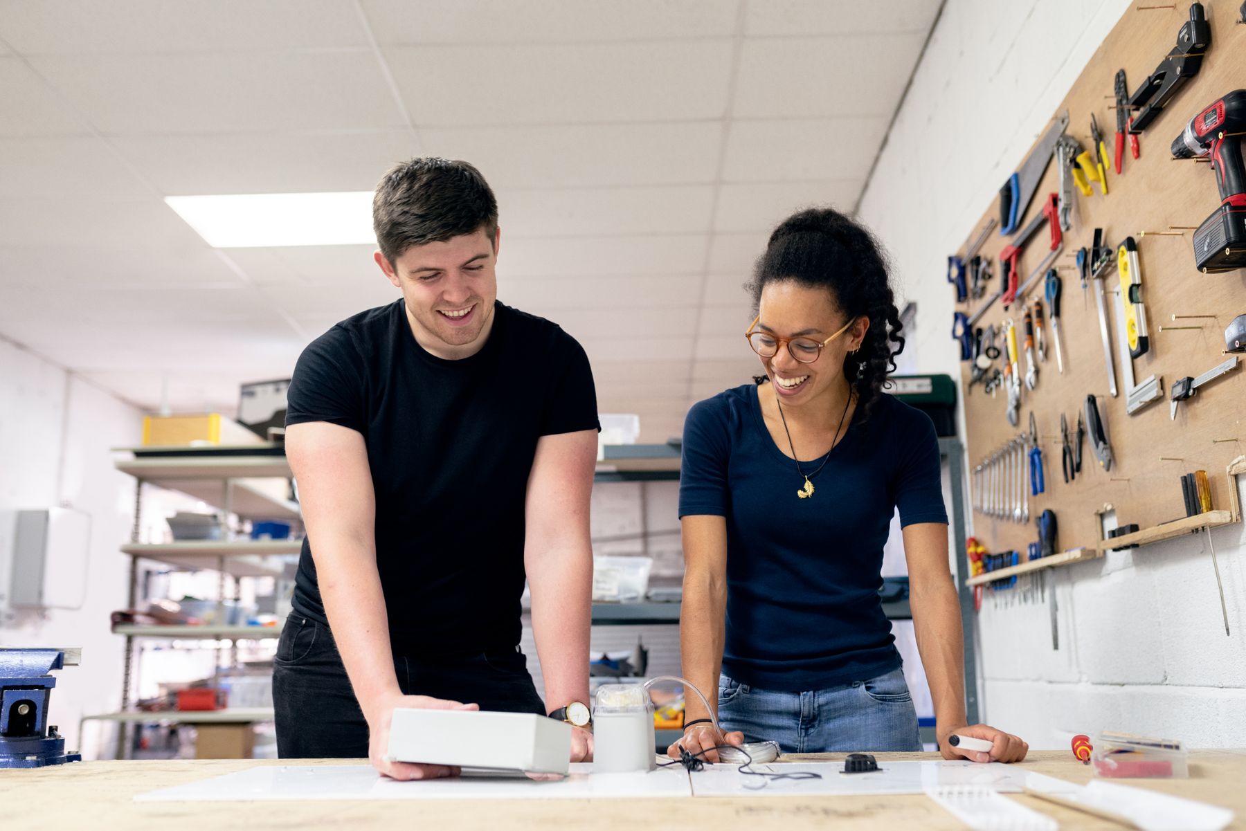 Two engineers testing a prototype in a workshop