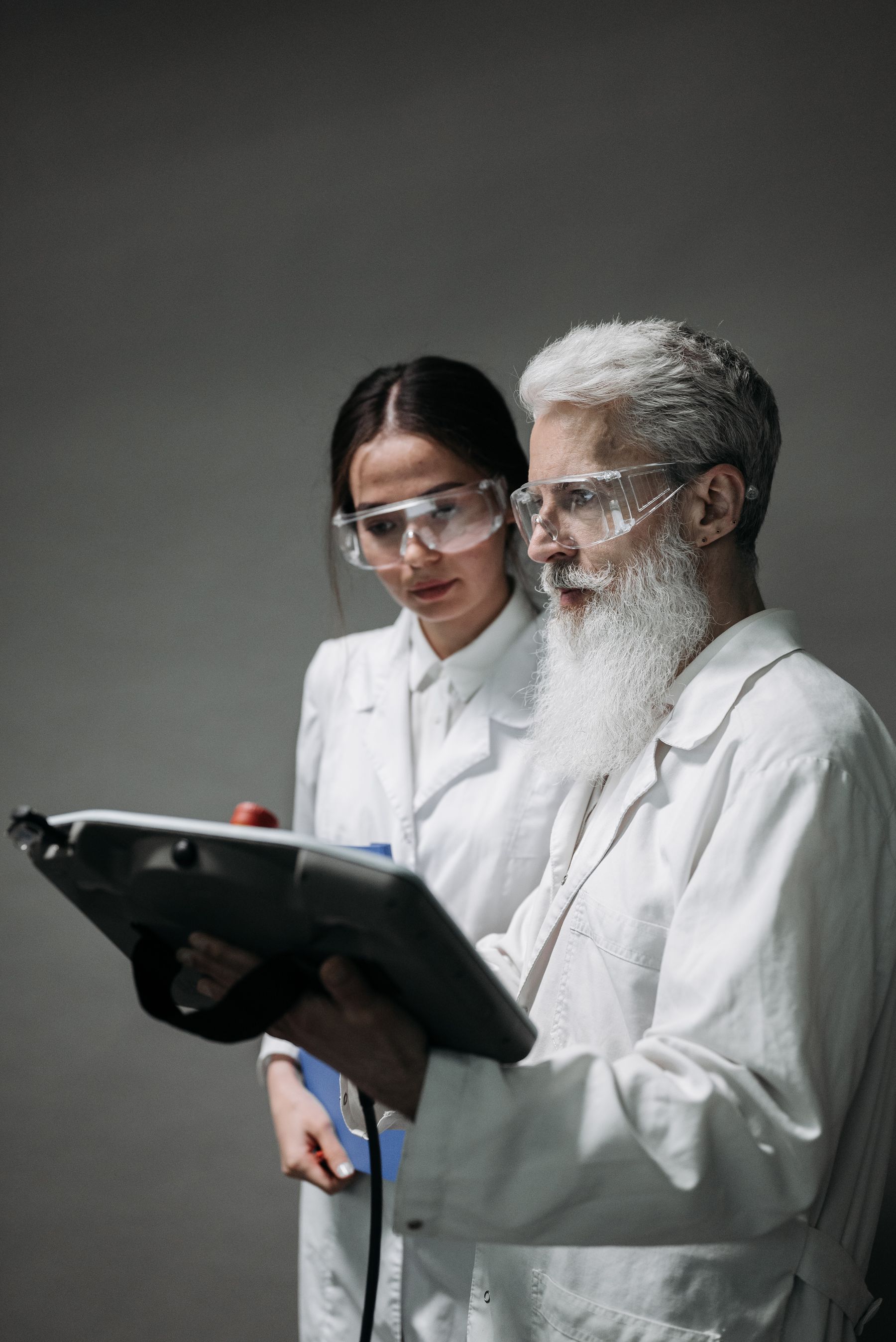 Two researchers reviewing information on a device together
